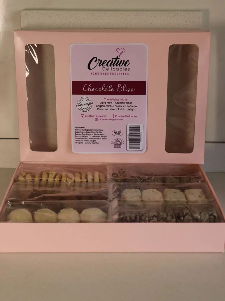 An open pink Creative Delicacies Chocolate Bliss box filled with six rows of handmade biscuits